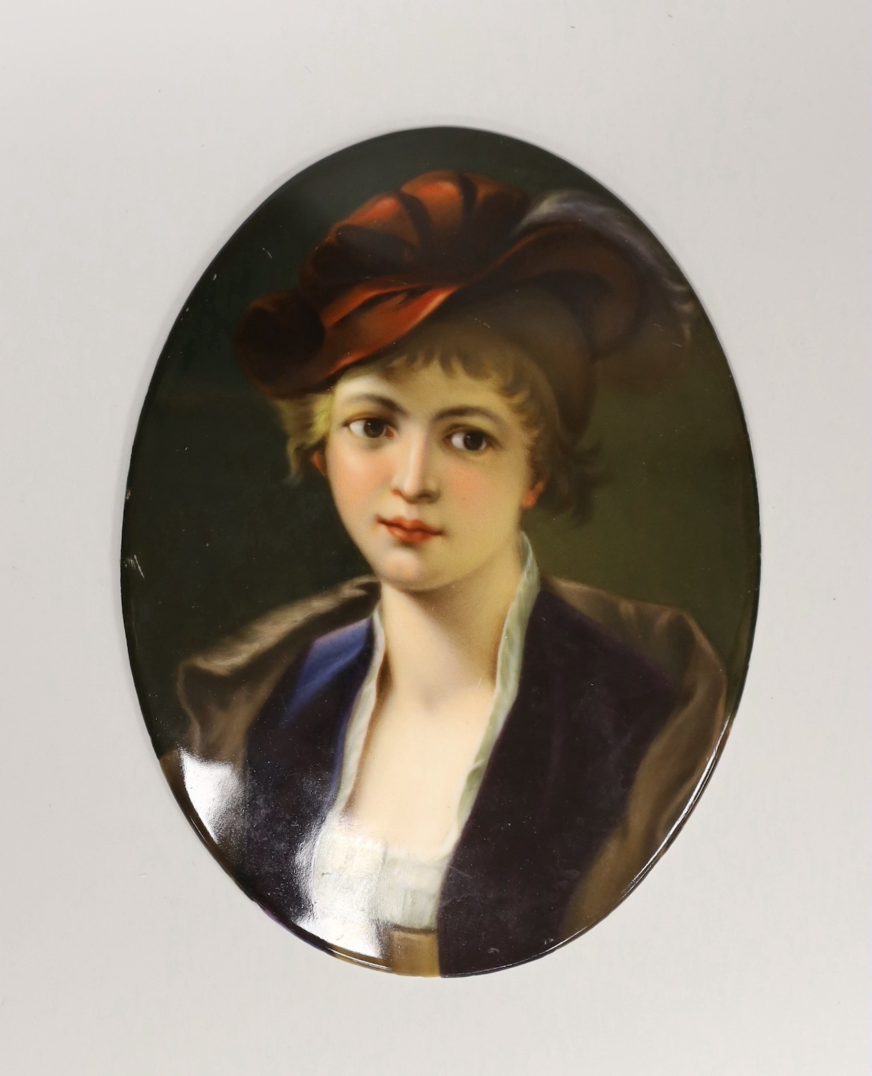 A 19th century oval painted porcelain plaque of a girl, 17 x 13cm